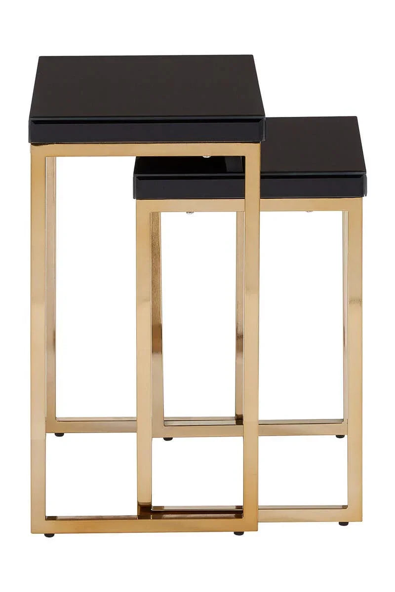 Black glass nesting tables with gold metal frames, modern square design, side view