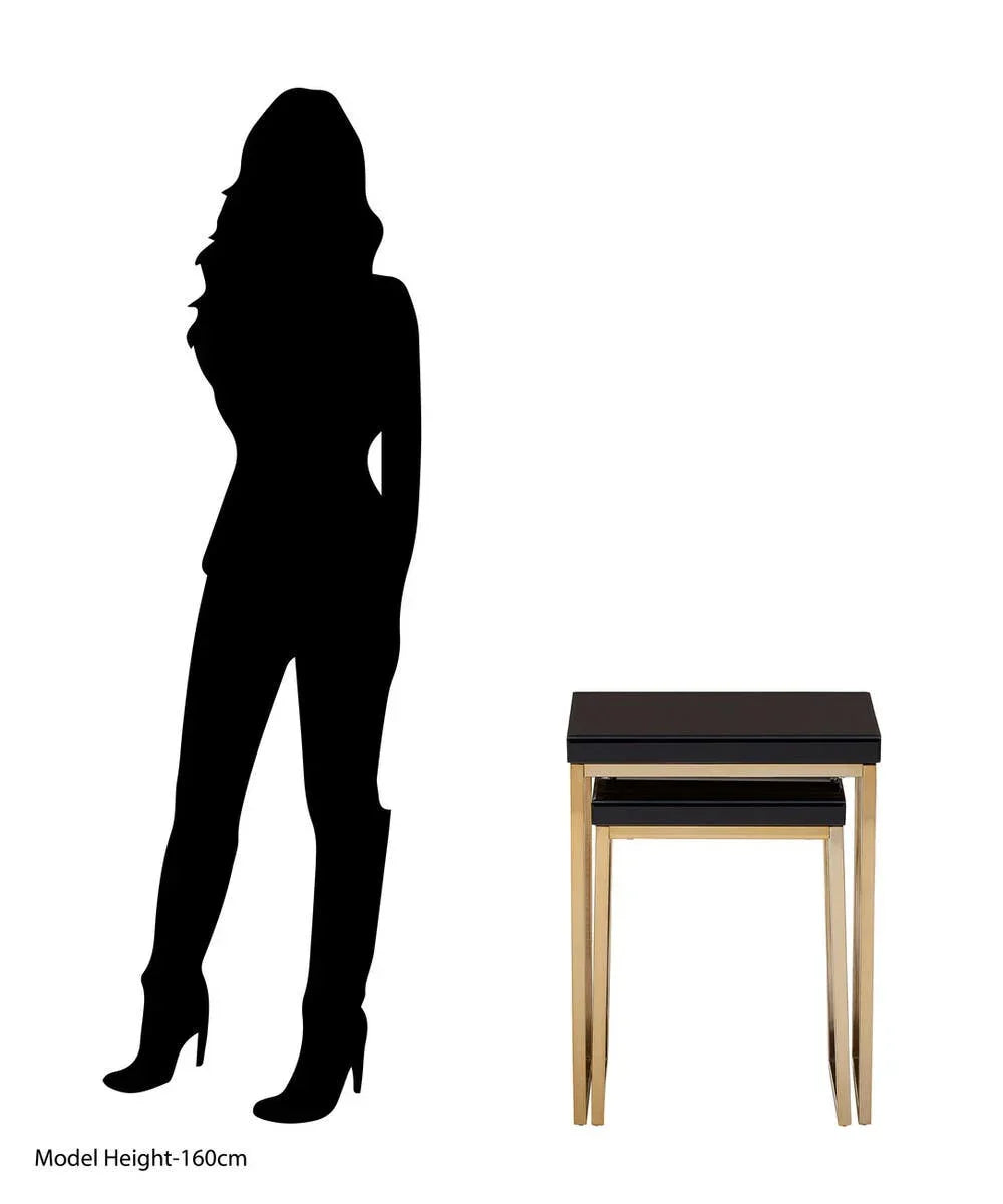Black glass top nesting tables with gold legs beside silhouette for size comparison