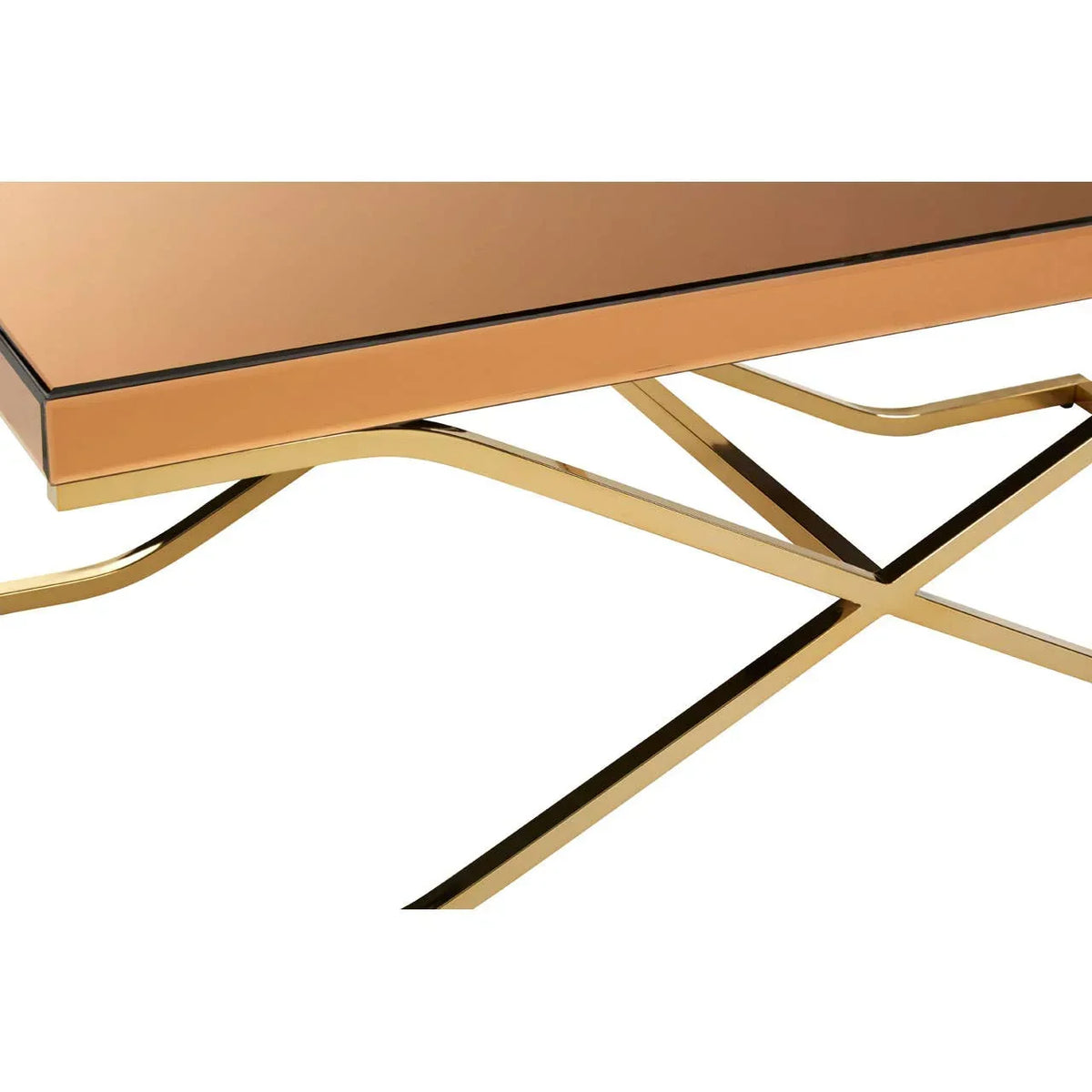 Rectangular glass coffee table with gold crossed metal legs, close-up corner view