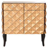 A stylish cabinet featuring a geometric pattern on the front, with a warm copper finish and two doors. The cabinet has four small, round knobs and stands on four slender black legs, adding a modern touch to its design