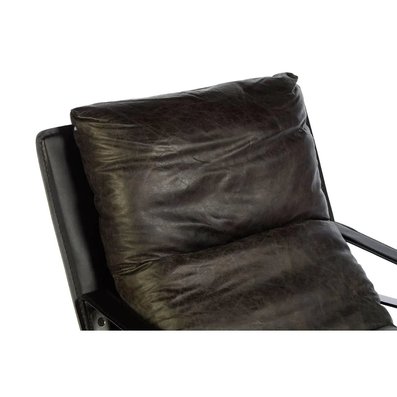 Closeup of dark leather armchair backrest cushion and arm detail