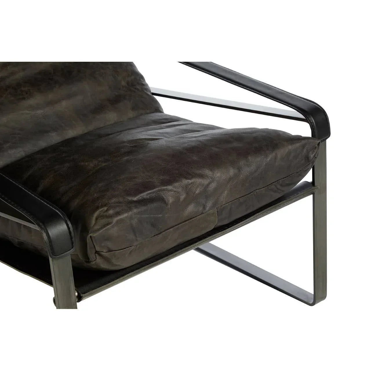 Brown leather accent chair with metal frame and padded seat cushion close up