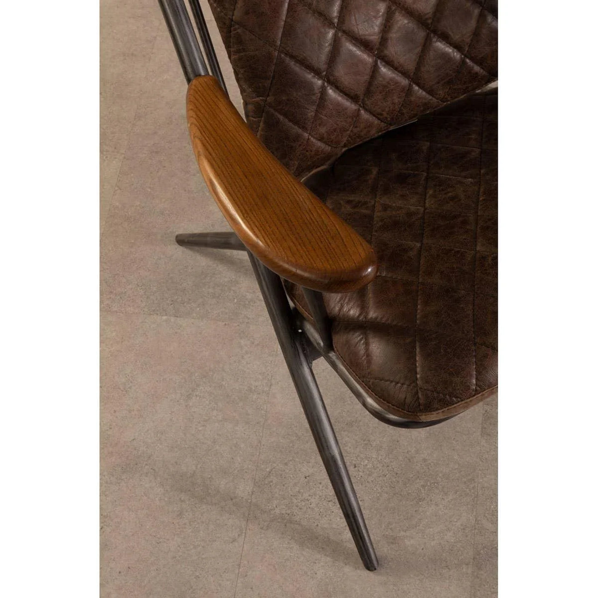 Brown leather dining chair with quilted seat and wooden armrest on metal frame