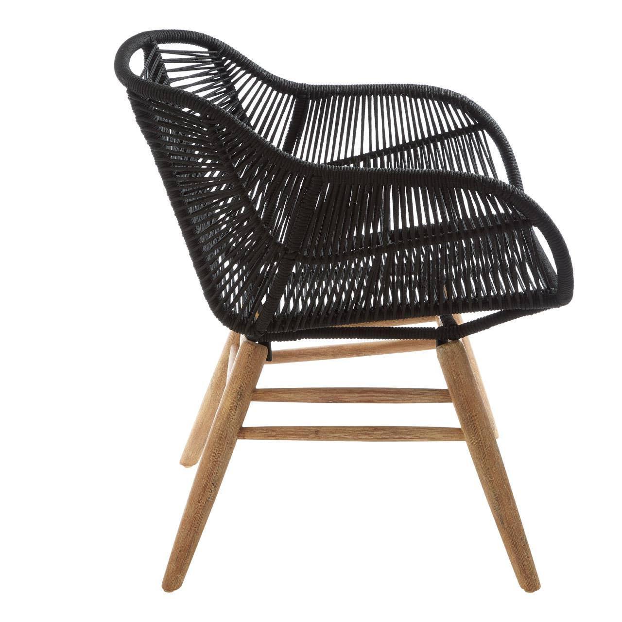 Black rattan accent chair with woven seat and wooden legs, side profile view
