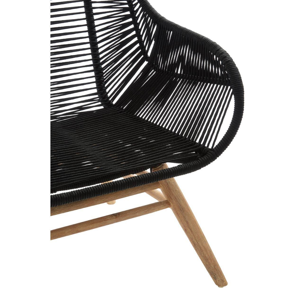 Black woven rattan lounge chair with wooden legs, close view of seat and armrest