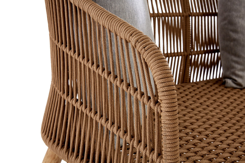 Woven rope sofa with a three-seater design, featuring a sturdy frame and a textured surface. The armrest has a rounded shape, and the woven pattern showcases a natural brown color. Soft cushions are placed on the seat, adding comfort and style