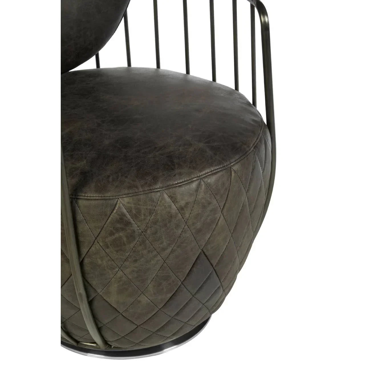 Close-up of quilted leather chair seat with metal armrest detail