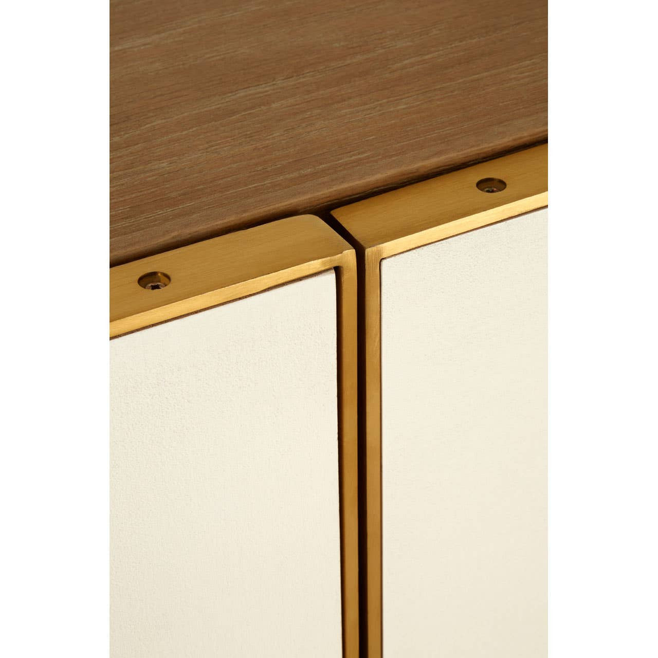 Close-up view of the Modica Oak Wood and Brushed Gold Cabinet, highlighting the seamless joint between the oak wood top and the brushed gold trim along the cabinet doors. The surface features a warm oak finish, while the gold accents add a touch of elegance