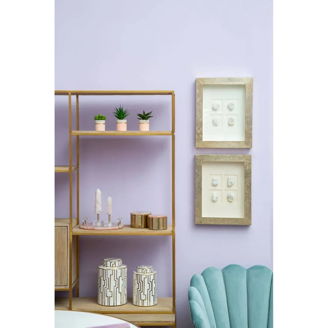 Wooden shelving unit with decor, ceramic storage jars, and green velvet accent chair