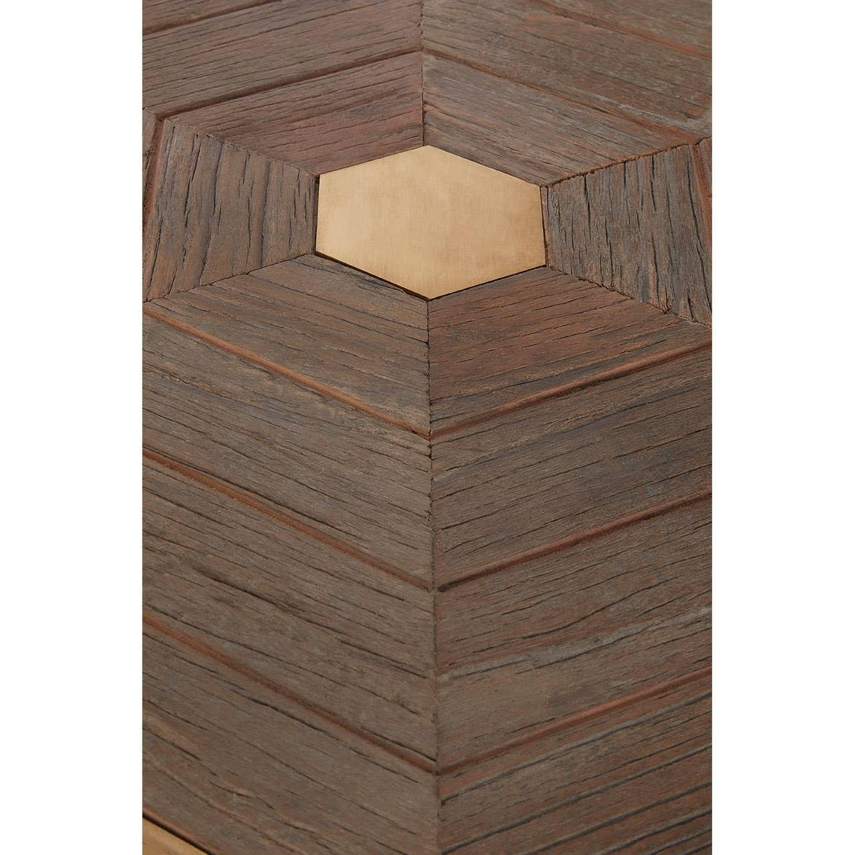 Wooden table surface with geometric chevron pattern and central hexagonal inlay detail