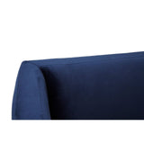 Close-up view of the armrest of a navy velvet three-seater sofa, showcasing its smooth texture and clean lines. The rich blue color adds a touch of elegance, while the plush fabric suggests comfort and style