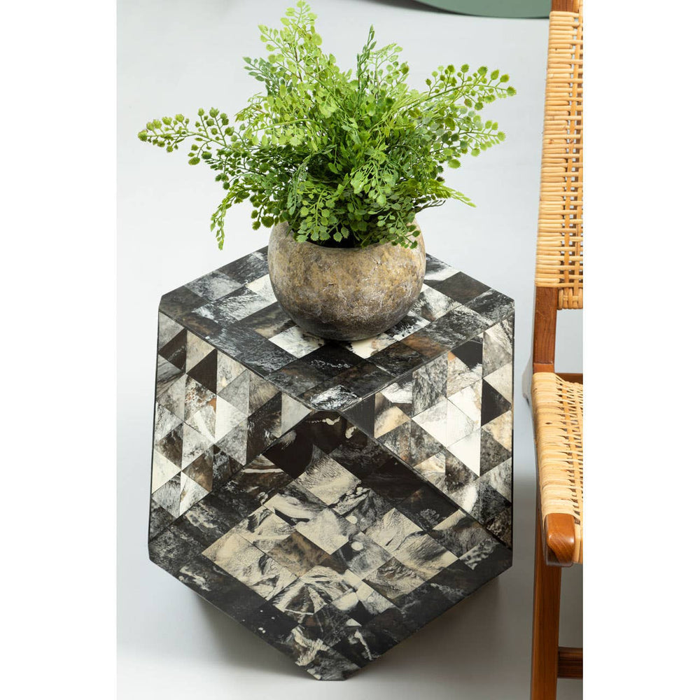 Antique green mosaic geometric hexagon side table with a reflective surface, featuring a small potted plant on top. The table has a unique hexagonal shape and is positioned next to a wooden chair, showcasing its decorative design and functionality in a home setting