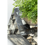 Antique green mosaic geometric hexagon side table featuring a textured surface with a mix of green, black, and cream tiles arranged in a geometric pattern. A small potted plant sits on top, adding a touch of greenery to the design. The table has a unique, angular shape that enhances its artistic appeal