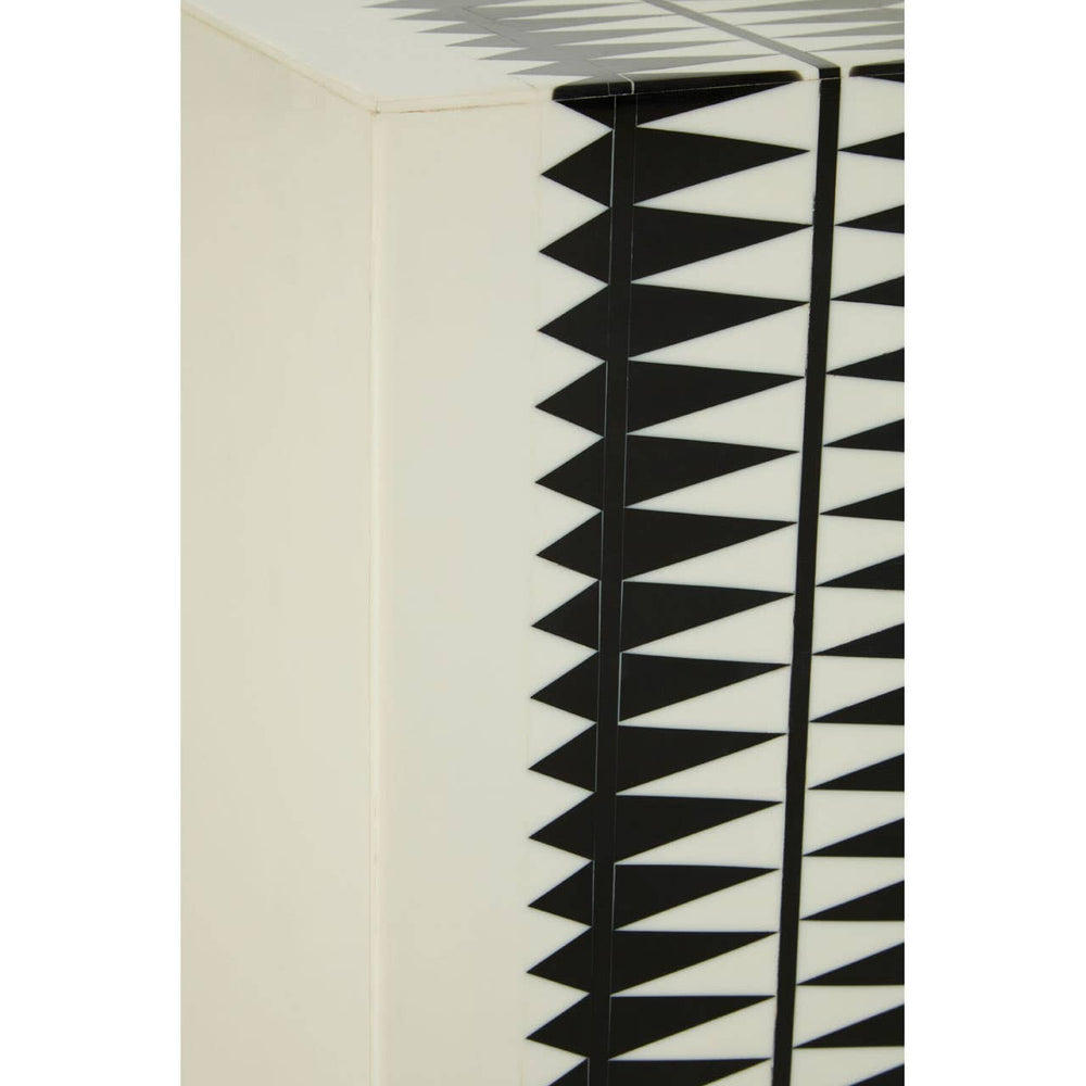 A close-up view of the Issey Black and White Resin Table and Stool, showcasing a textured surface with a geometric pattern of black spikes against a cream background. The design emphasizes a modern aesthetic, highlighting the contrast between the black and white colors