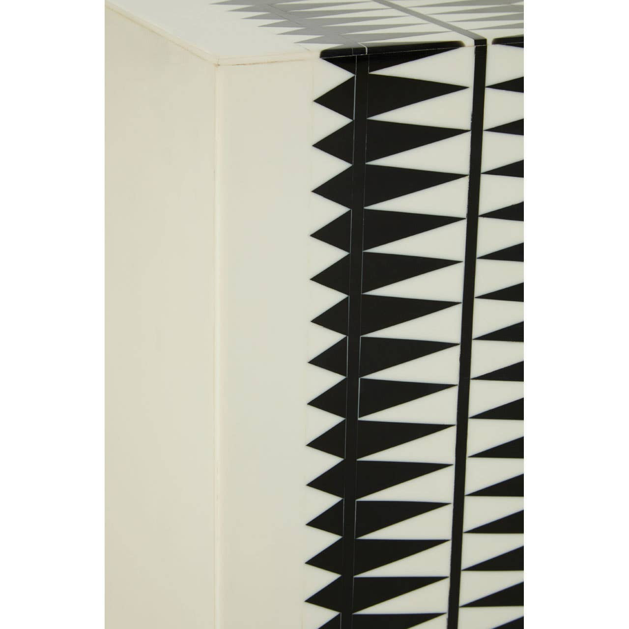 A close-up view of the Issey Black and White Resin Table and Stool, showcasing a textured surface with a geometric pattern of black spikes against a cream background. The design emphasizes a modern aesthetic, highlighting the contrast between the black and white colors