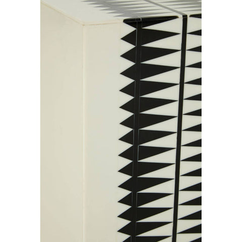 A close-up view of the Issey Black and White Resin Table and Stool, showcasing a textured surface with a geometric pattern of black spikes against a cream background. The design emphasizes a modern aesthetic, highlighting the contrast between the black and white colors