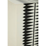 A close-up view of the Issey Black and White Resin Table and Stool, showcasing a textured surface with a geometric pattern of black spikes against a cream background. The design emphasizes a modern aesthetic, highlighting the contrast between the black and white colors
