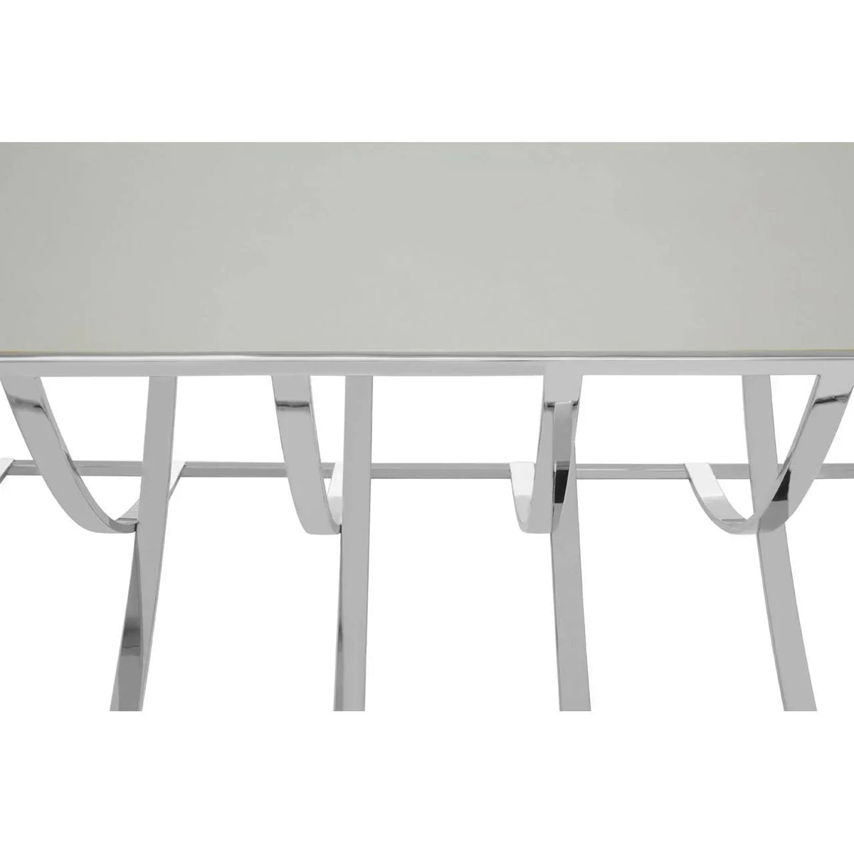 Modern glass dining table with chrome curved metal legs, viewed from above and front angle