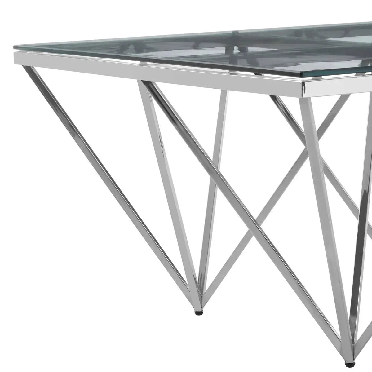 Glass dining table with chrome metal legs in geometric design, close-up side view