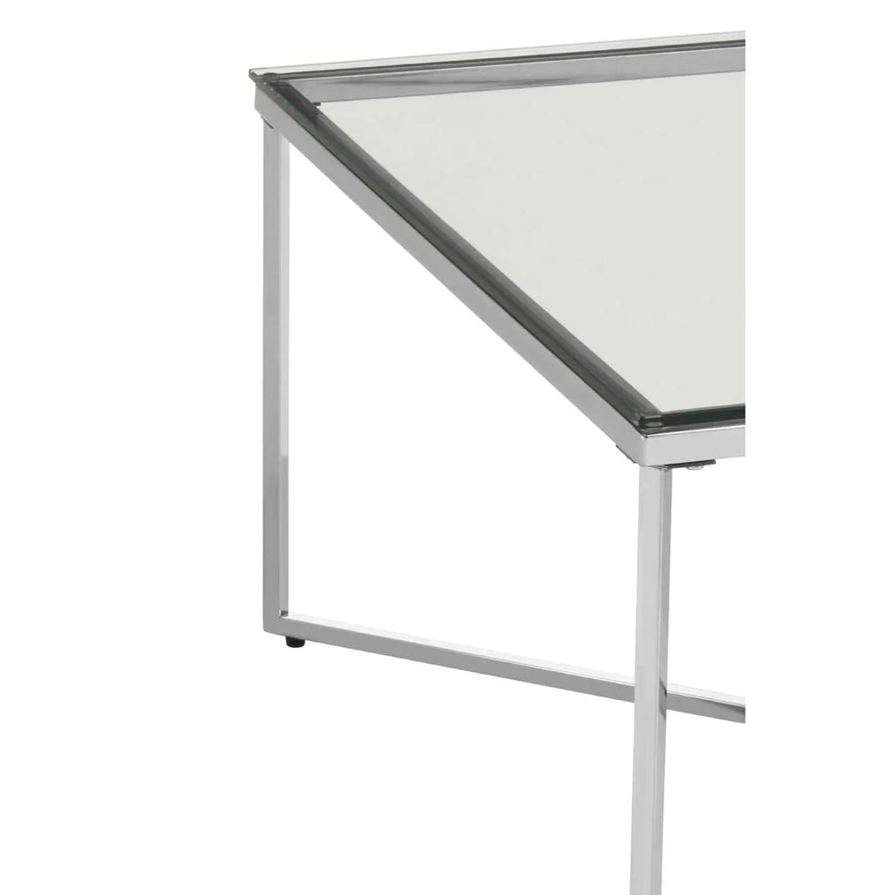 Close-up of glass coffee table with chrome metal frame and angular legs