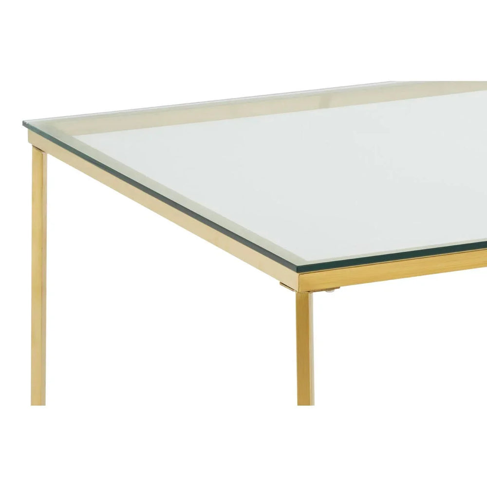 Glass dining table with gold metal frame, corner detail view