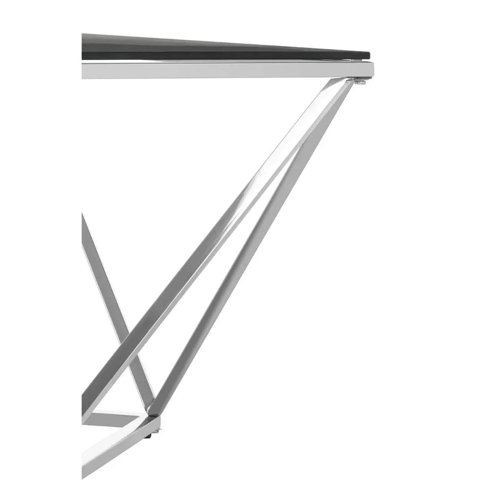 Chrome metal dining table legs with black glass top, angled close-up view