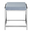 A powder blue velvet stool with a cushioned top and a sleek silver metal frame, featuring a minimalist design with clean lines and a sturdy base. The stool has a square shape and is positioned with its top facing upward, showcasing the soft texture of the velvet fabric