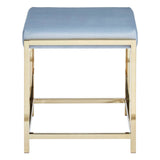 A powder blue velvet stool with a rectangular seat and a sleek gold metal frame, featuring a crossbar for added stability. The design is modern and elegant, suitable for various home decor styles