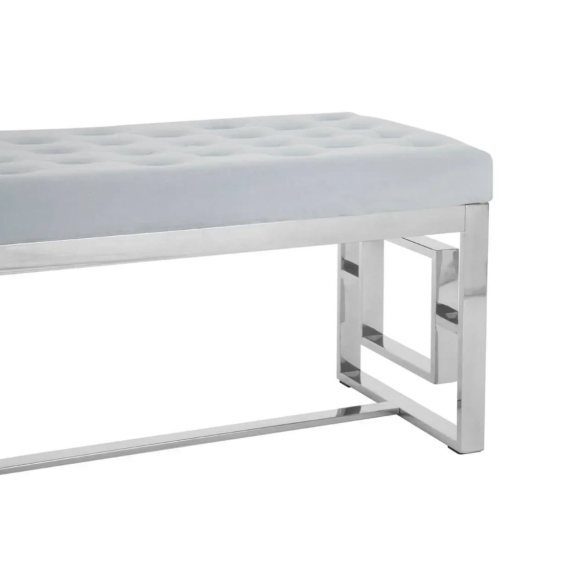 Grey velvet bench with tufted seat and chrome metal legs, side angle view