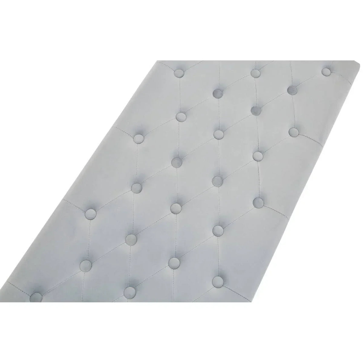 Closeup of grey tufted upholstered headboard with button detail