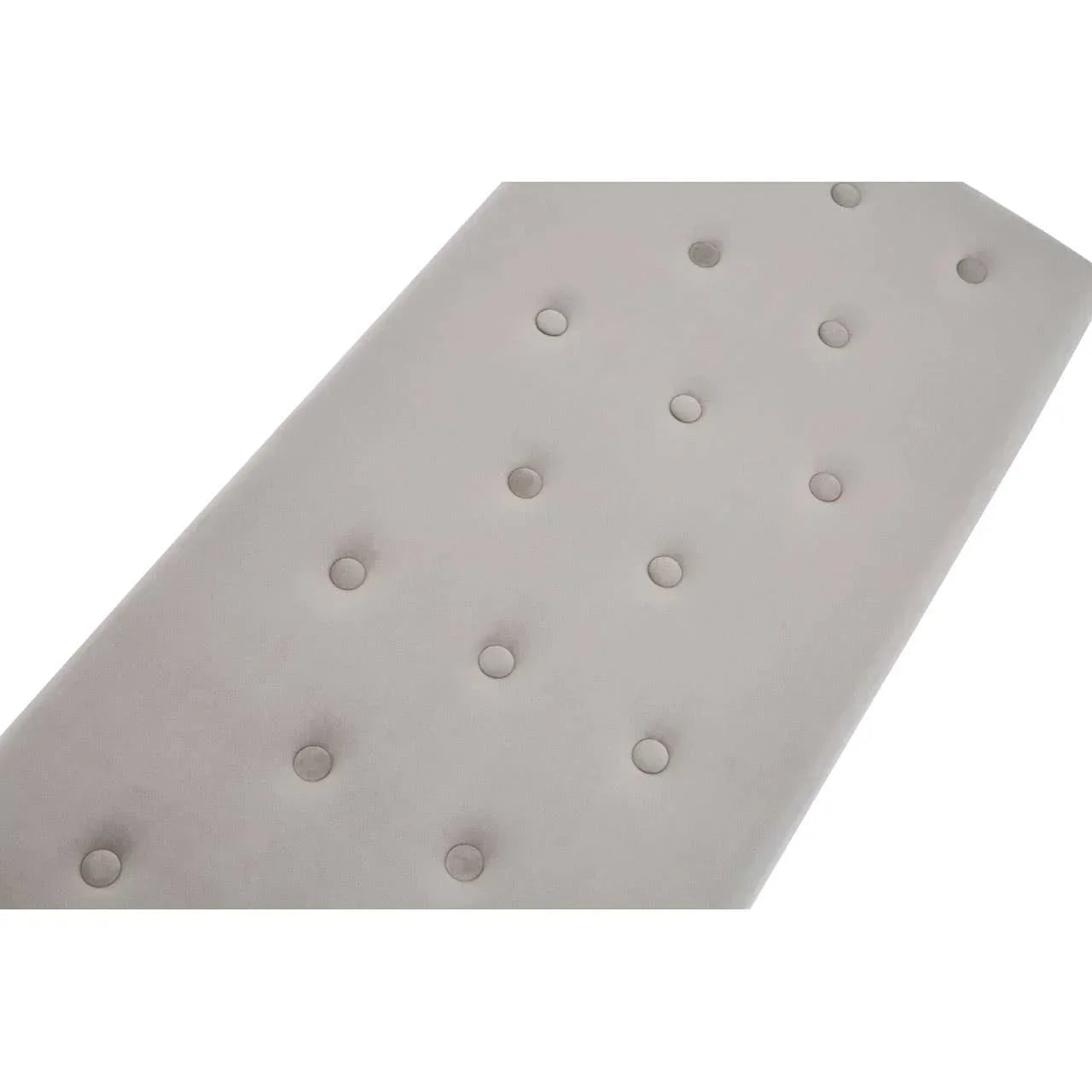 Close-up of beige upholstered bench seat with button tufting detail