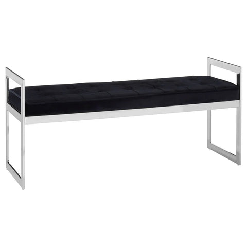 Black velvet bench with tufted seat and chrome metal frame, rectangular armrests, side angle
