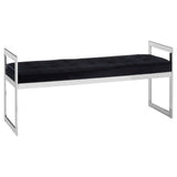 Black velvet bench with tufted seat and chrome metal frame, rectangular armrests, side angle