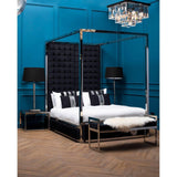Black velvet four poster bed with chrome frame, bench and bedside tables in modern bedroom