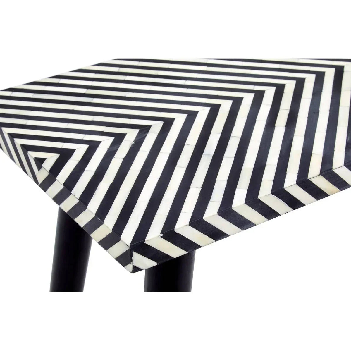 Black and white geometric patterned coffee table corner with tapered black legs