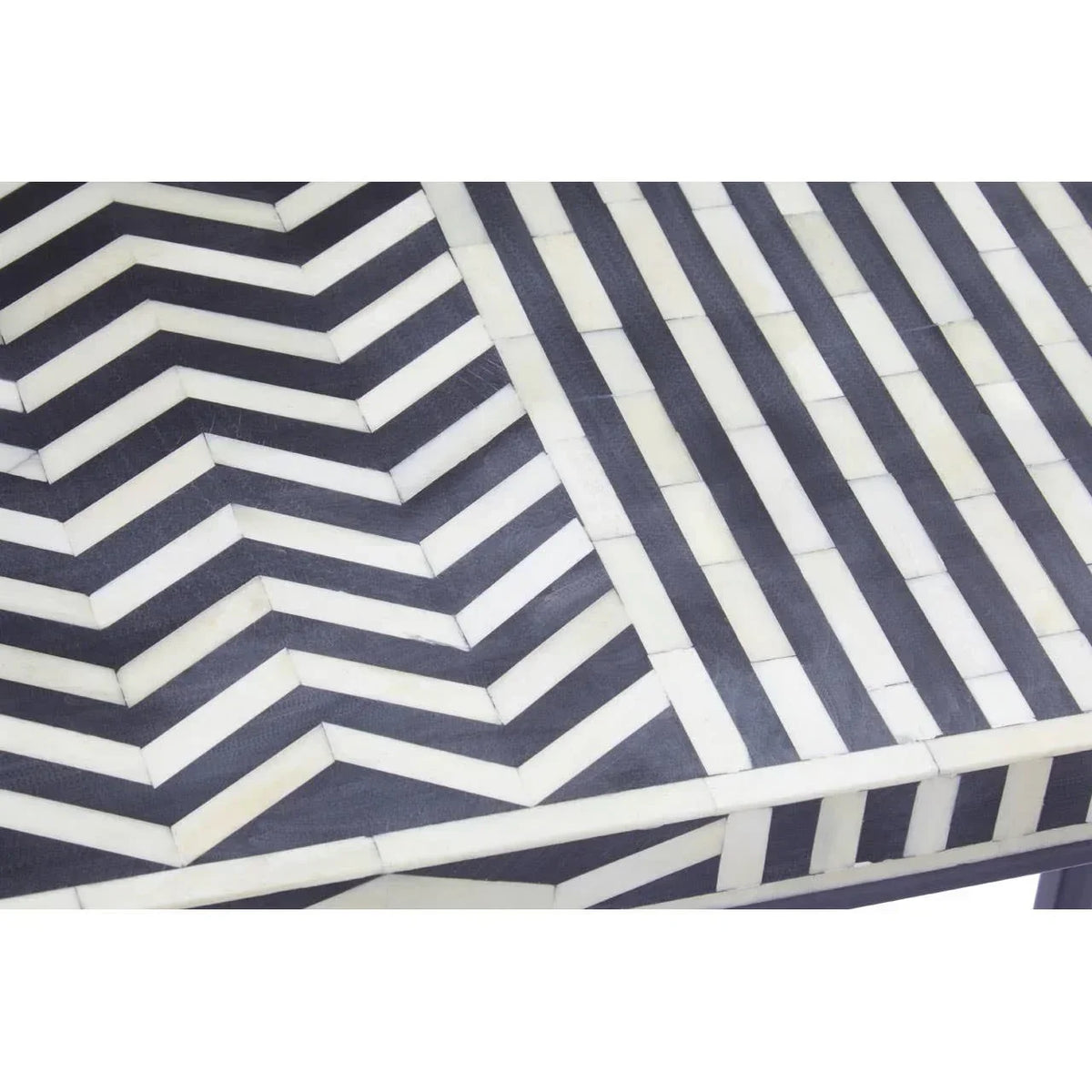Chevron patterned dining table with black and white bone inlay close up