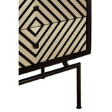 Boho mango wood chest featuring a patterned front with geometric designs in a natural and black color scheme, supported by slender metal legs. The chest includes five drawers for storage