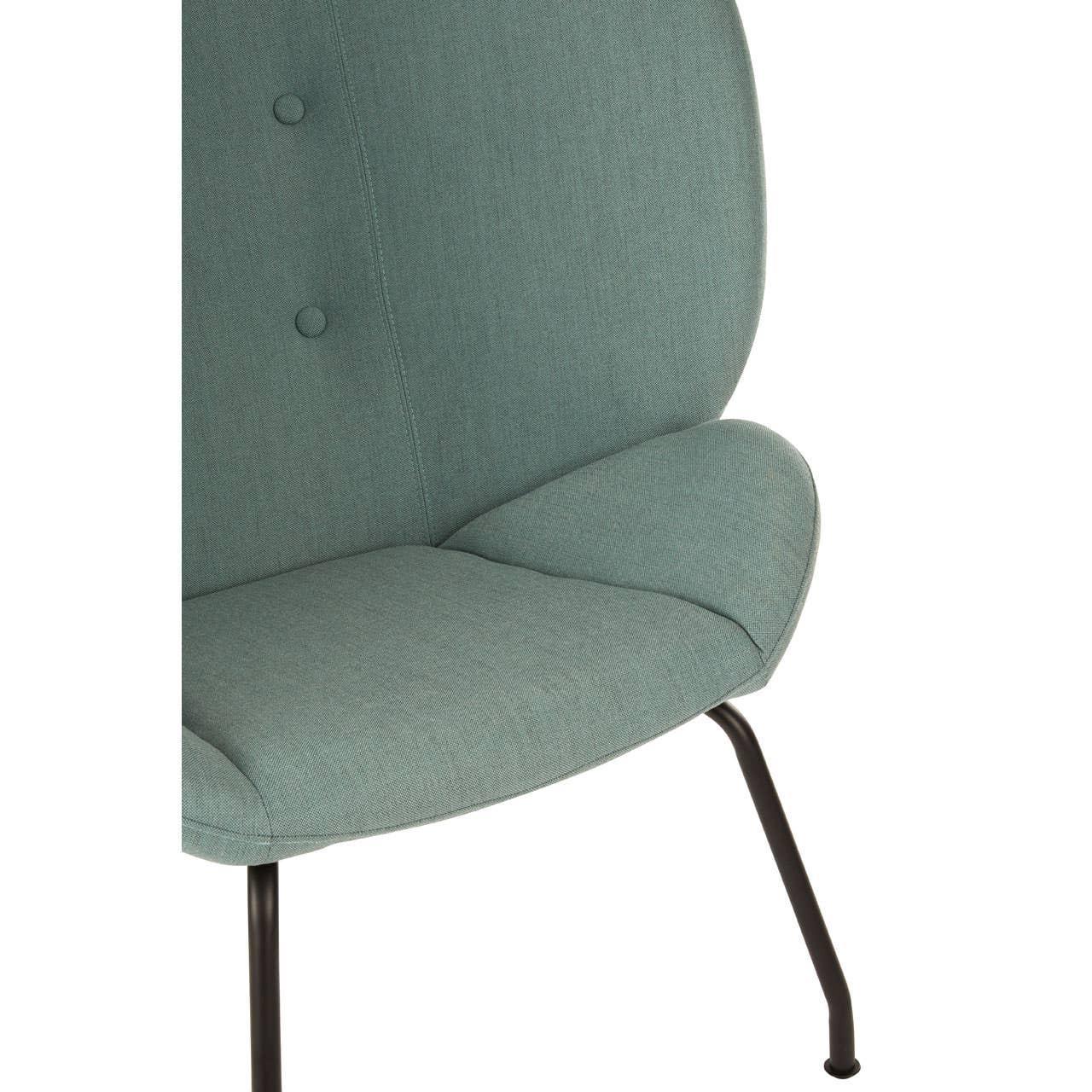 Close up of modern green fabric chair with buttoned backrest and black metal legs