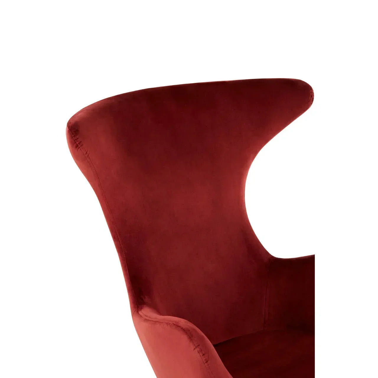 Red velvet accent chair with curved high backrest, close up view