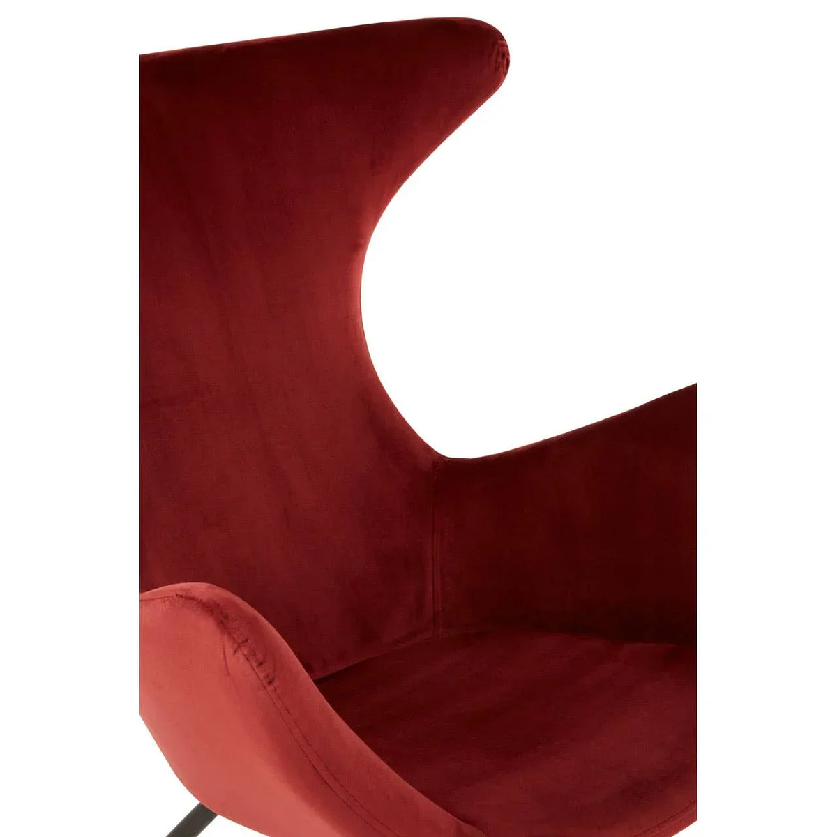 Close up of modern velvet accent chair with curved backrest in deep red upholstery