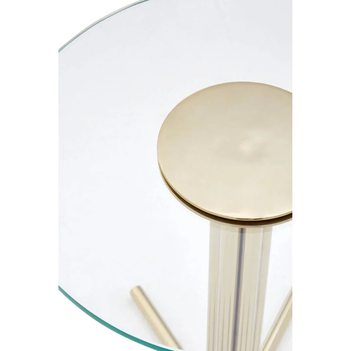 Glass top dining table with gold metal pedestal base, closeup of leg and tabletop edge
