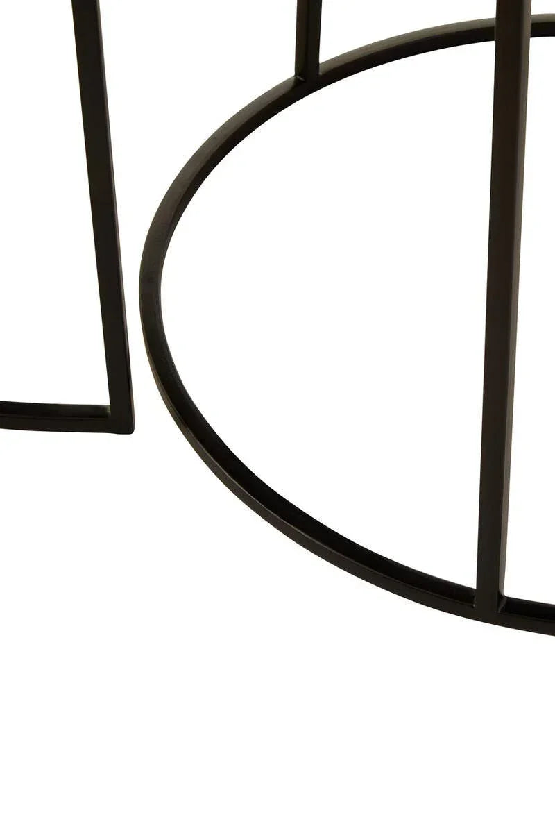 Closeup of round black metal table base with open frame design