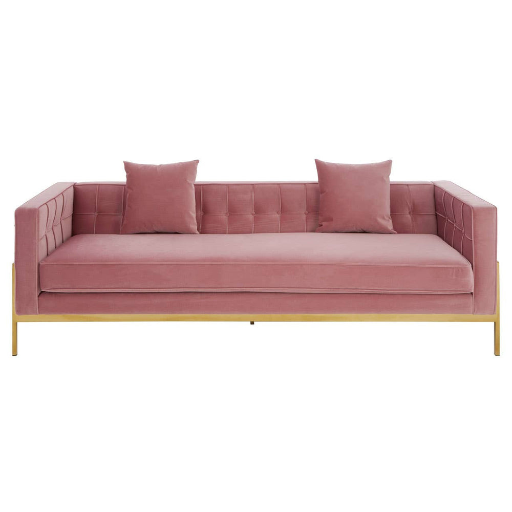 Three-seat pink sofa with a tufted backrest, two matching cushions, and sleek gold legs. The fabric has a soft texture, and the overall design is modern and minimalist