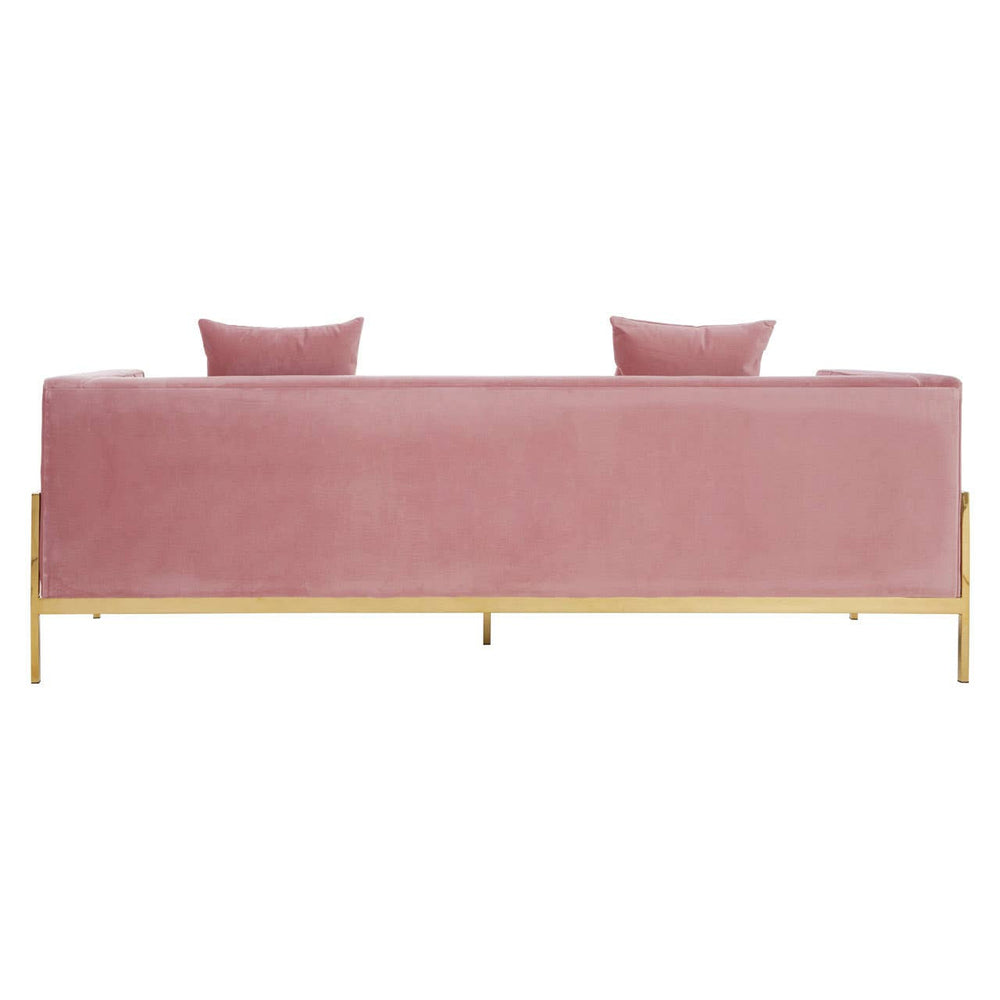 Three-seat sofa upholstered in soft pink fabric, featuring a sleek design with two matching cushions on the backrest. The sofa is supported by slender gold legs, giving it a modern and elegant appearance