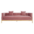 Three-seat pink sofa with a tufted backrest, two matching cushions, and sleek gold legs. The fabric has a soft texture, and the overall design is modern and elegant