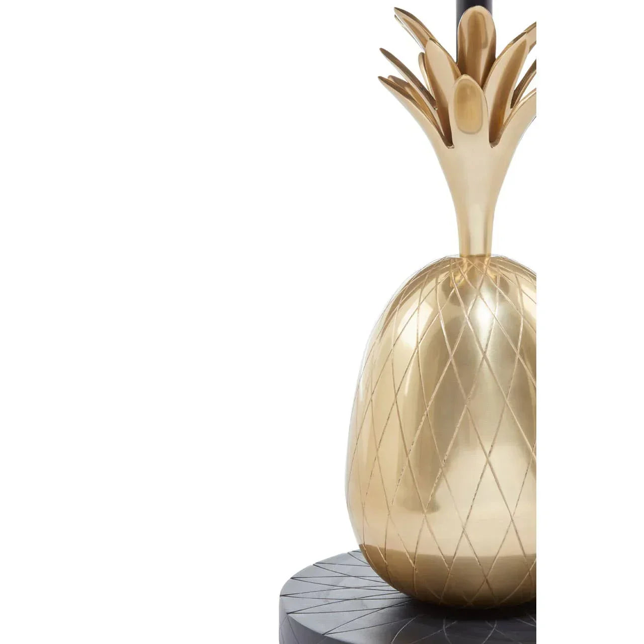 Gold pineapple decor ornament with diamond pattern on dark round table