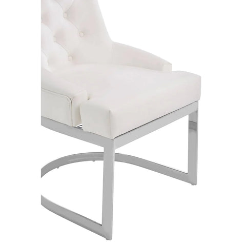 White upholstered dining chair with chrome metal legs and tufted backrest, angled side view