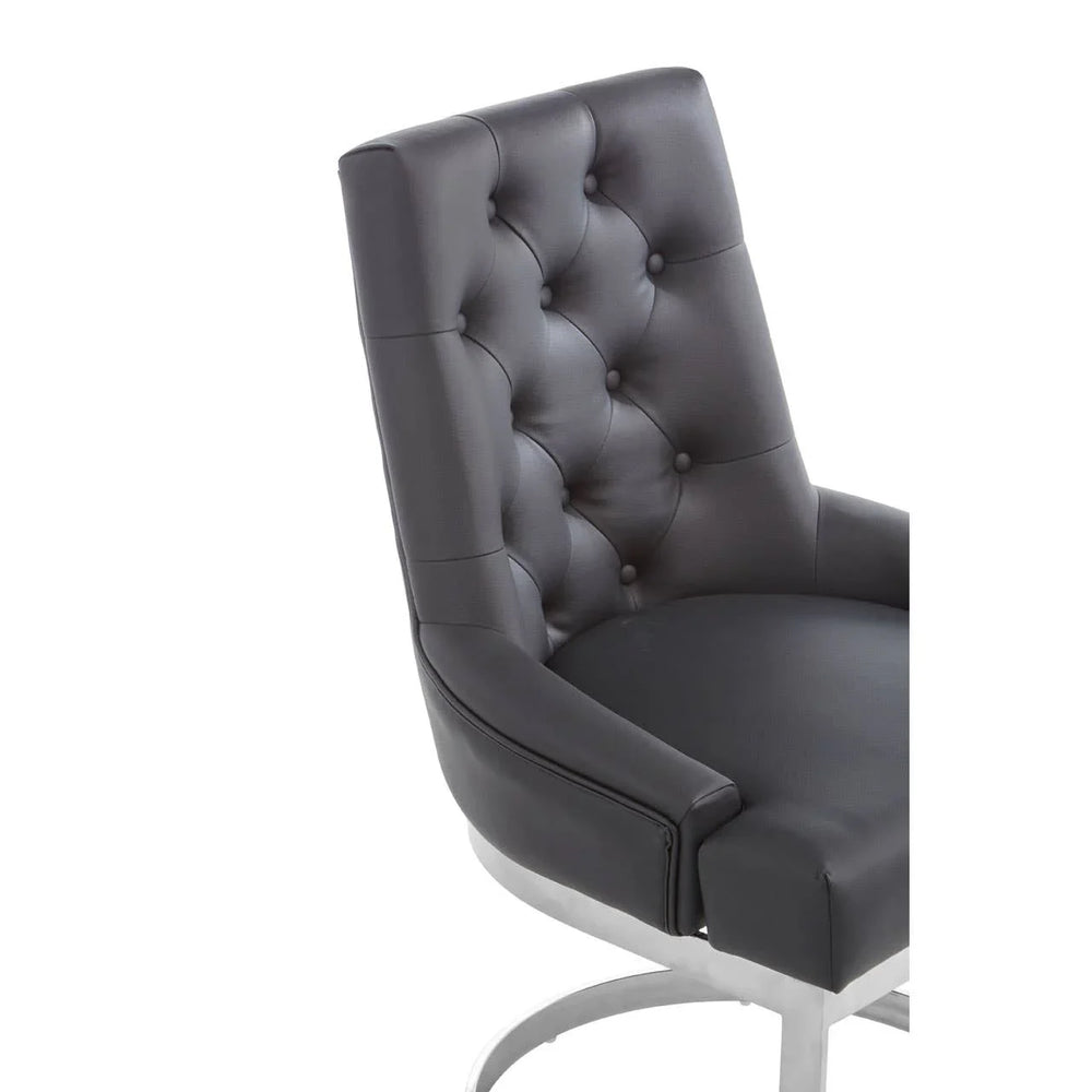 Black tufted leather dining chair with chrome base, angled side view