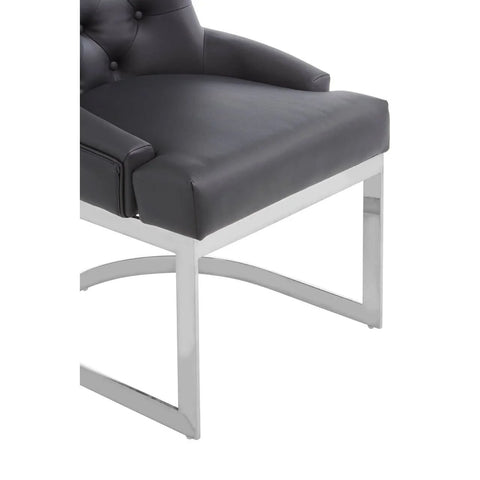 Black faux leather dining chair with chrome metal legs close-up