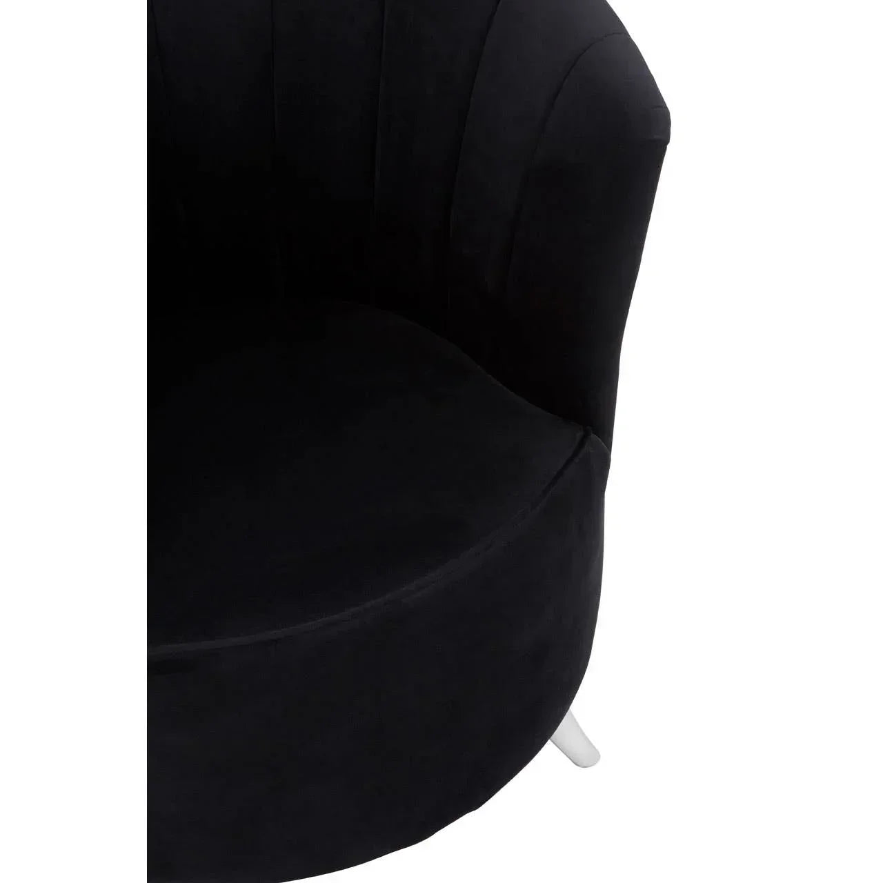 Black velvet accent chair with curved backrest and white angled leg, close-up view